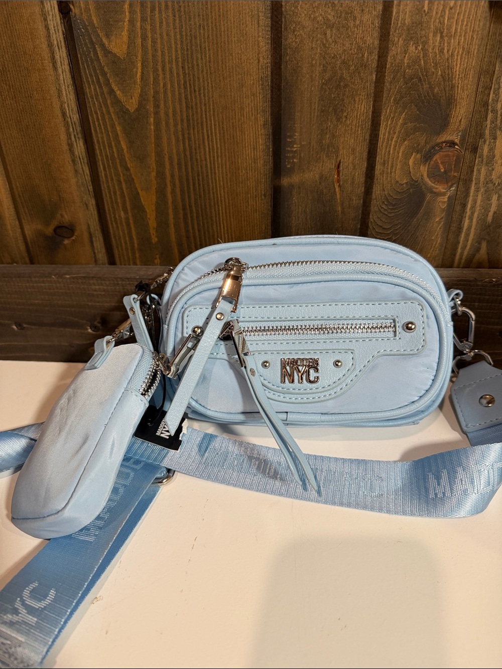 Light Blue Crossbody Bag with Detachable Pouch and Branded Metal Accent